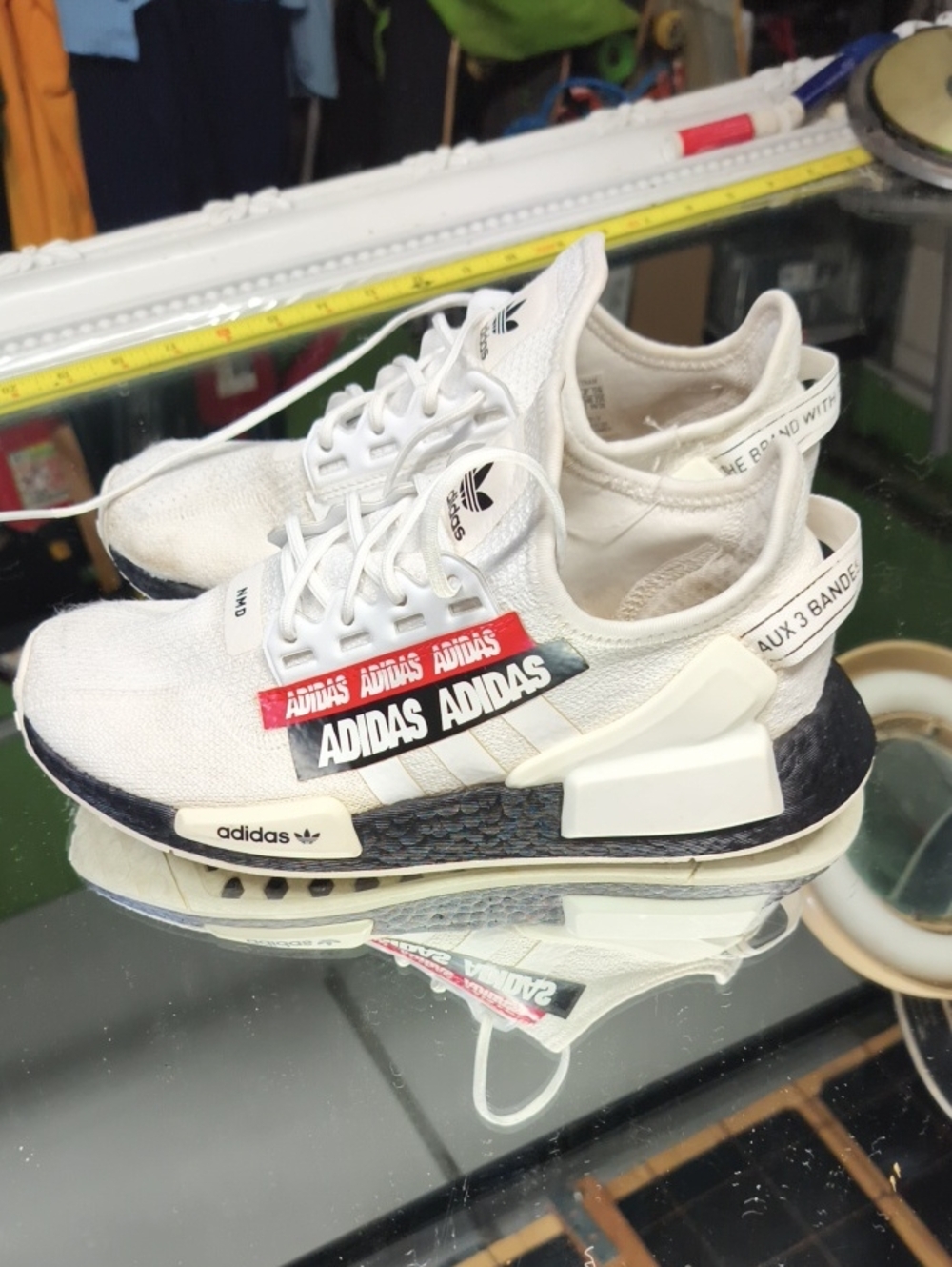 Womens 5.5 NMD_R1 V2 "Overbranded" sneakers white colorway featuring bold black